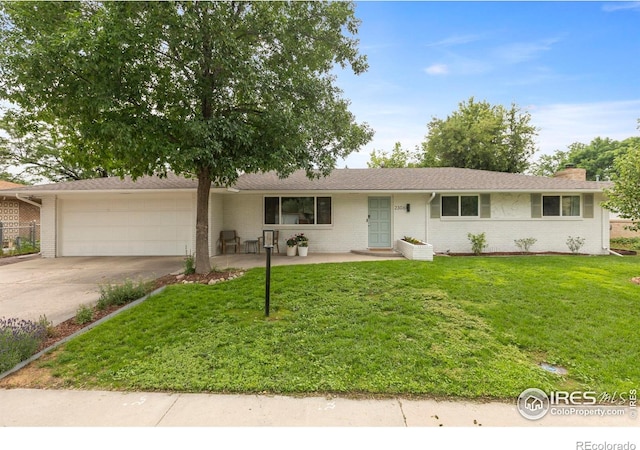 2306 Ptelea Ct, Loveland, CO 80538 - single story home featuring an attached garage, driveway, brick siding, a front yard, and a chimney