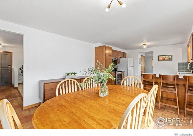 2306 Ptelea Ct, Loveland, CO 80538 - dining area featuring stairway and baseboards