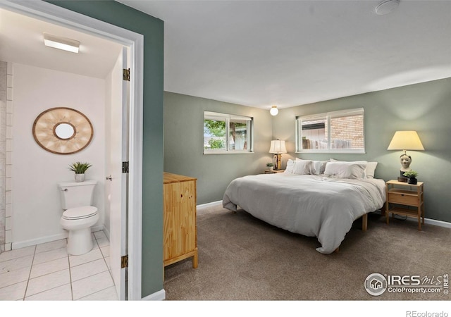 2306 Ptelea Ct, Loveland, CO 80538 - tiled bedroom featuring baseboards and ensuite bath