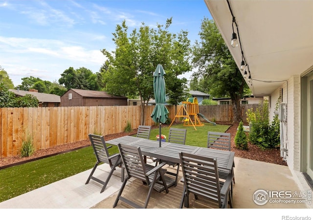 2306 Ptelea Ct, Loveland, CO 80538 - fenced backyard featuring outdoor dining space, a patio area, and a playground