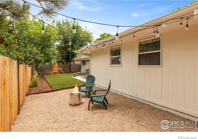 2306 Ptelea Ct, Loveland, CO 80538 - fenced backyard featuring a playground and a patio