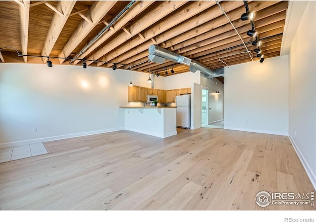 1941 Pearl St Unit 303, Boulder, CO 80302 - unfurnished living room featuring light wood-style flooring and rail lighting