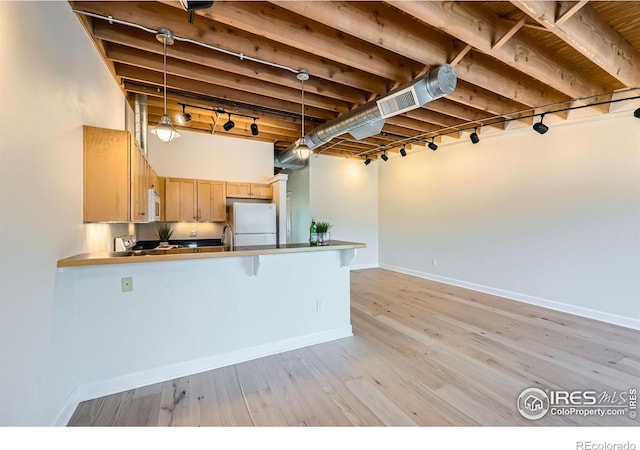 1941 Pearl St Unit 303, Boulder, CO 80302 - kitchen with white appliances, a peninsula, light wood-type flooring, light brown cabinetry, and pendant lighting