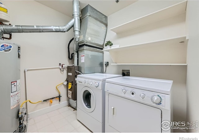 1941 Pearl St Unit 303, Boulder, CO 80302 - laundry room with gas water heater, washing machine and dryer, and light floors