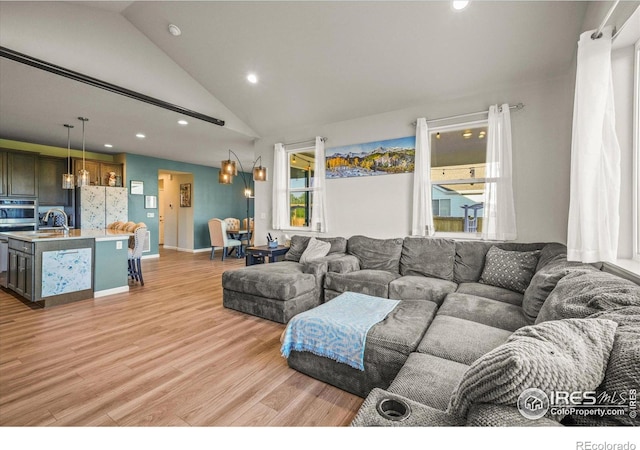 437 Buckskin Rd, Berthoud, CO 80513 - living room with vaulted ceiling, light wood finished floors, and recessed lighting