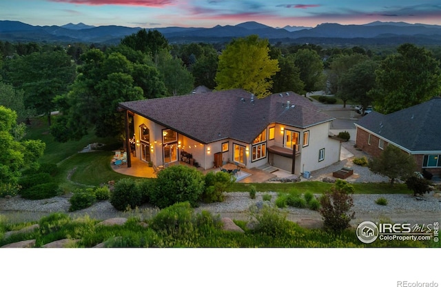 4926 Saint Andrews Ct, Loveland, CO 80537 - view of front of house with stucco siding, a mountain view, and a garage