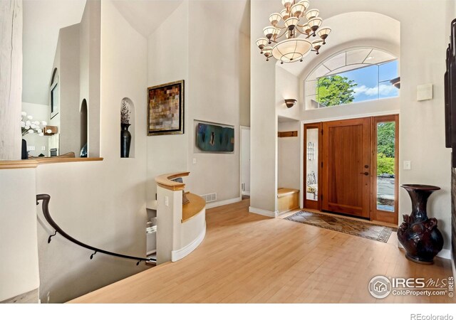 4926 Saint Andrews Ct, Loveland, CO 80537 - foyer featuring a high ceiling, wood finished floors, and a chandelier