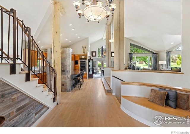 4926 Saint Andrews Ct, Loveland, CO 80537 - foyer featuring vaulted ceiling, wood finished floors, recessed lighting, a chandelier, and stairway
