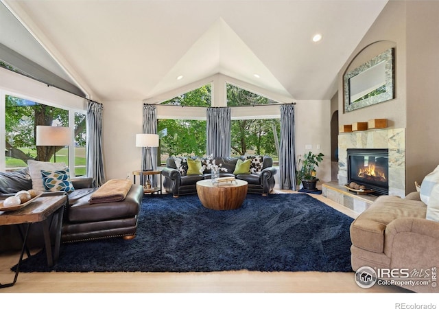 4926 Saint Andrews Ct, Loveland, CO 80537 - living room featuring vaulted ceiling, a high end fireplace, recessed lighting, and wood finished floors