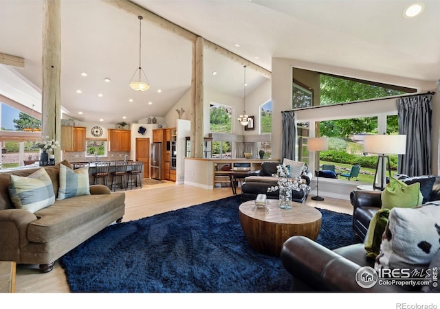 4926 Saint Andrews Ct, Loveland, CO 80537 - living room with a chandelier, light wood-type flooring, high vaulted ceiling, recessed lighting, and beamed ceiling