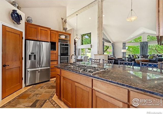4926 Saint Andrews Ct, Loveland, CO 80537 - kitchen with appliances with stainless steel finishes, lofted ceiling, pendant lighting, open shelves, and dark stone counters