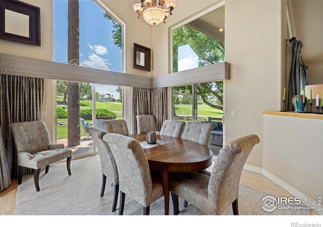 4926 Saint Andrews Ct, Loveland, CO 80537 - dining space with a high ceiling, a chandelier, and wood finished floors