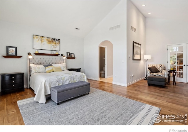 4926 Saint Andrews Ct, Loveland, CO 80537 - bedroom with arched walkways, high vaulted ceiling, wood finished floors, and recessed lighting