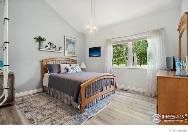 4926 Saint Andrews Ct, Loveland, CO 80537 - bedroom with light wood-style floors and vaulted ceiling