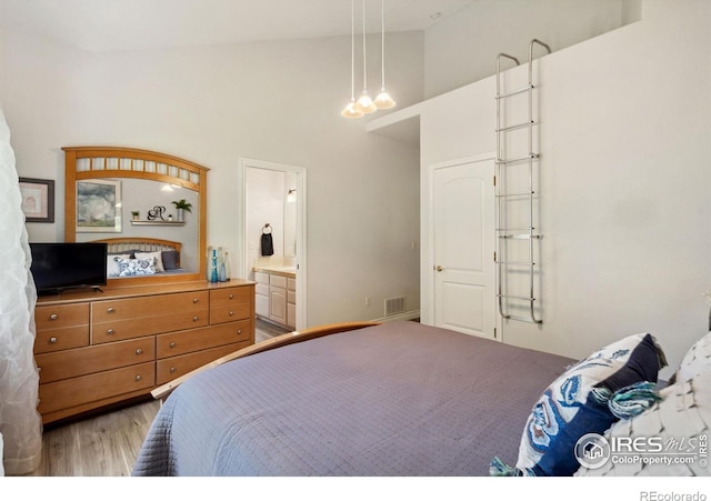 4926 Saint Andrews Ct, Loveland, CO 80537 - bedroom with high vaulted ceiling, wood finished floors, and connected bathroom