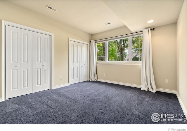 4926 Saint Andrews Ct, Loveland, CO 80537 - unfurnished bedroom featuring multiple closets and dark carpet