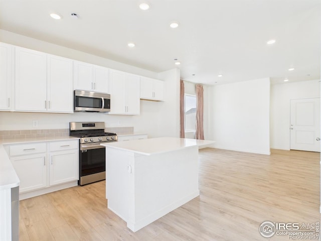 3840 Katmai Ave, Evans, CO 80620 - kitchen featuring stainless steel appliances, light wood-type flooring, light countertops, a center island, and recessed lighting