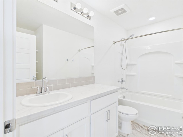 3840 Katmai Ave, Evans, CO 80620 - full bathroom featuring tub / shower combination, vanity, and decorative backsplash