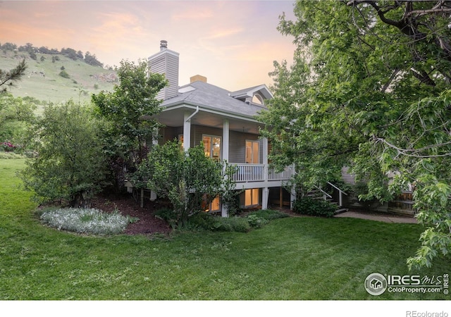3421 4th St, Boulder, CO 80304 - view of front of home with stairs, a front yard, a porch, and a chimney
