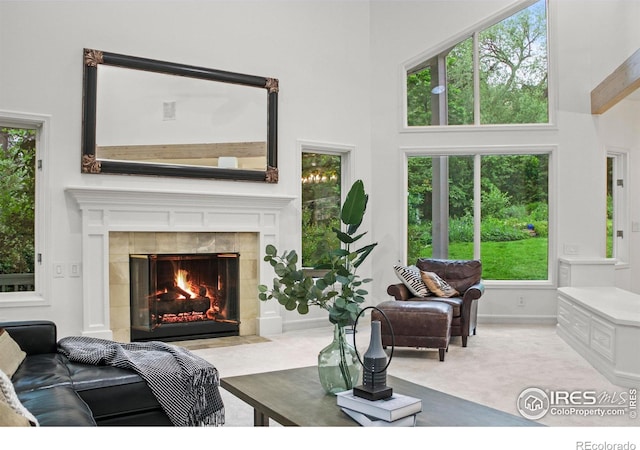 3421 4th St, Boulder, CO 80304 - carpeted living area featuring a high ceiling, a tiled fireplace, and healthy amount of natural light