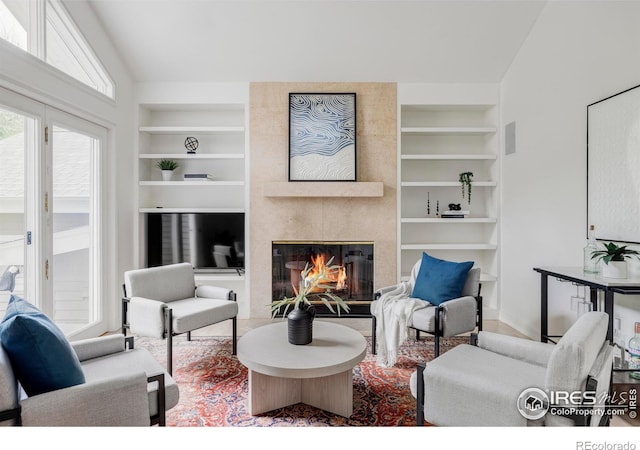 3421 4th St, Boulder, CO 80304 - living room featuring built in shelves, a fireplace, and vaulted ceiling