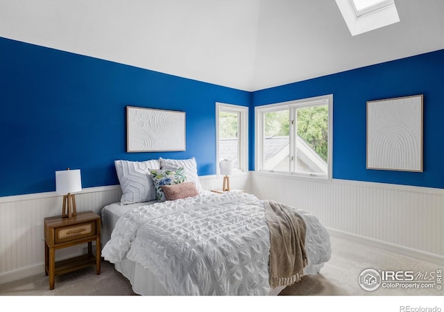 3421 4th St, Boulder, CO 80304 - carpeted bedroom featuring wainscoting, a skylight, and high vaulted ceiling
