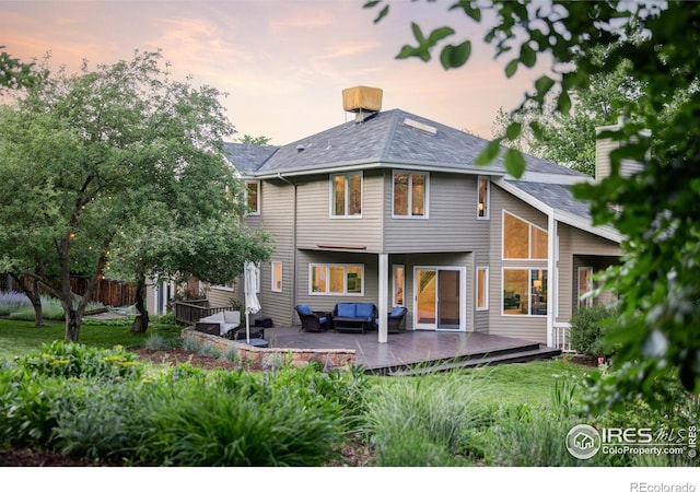 3421 4th St, Boulder, CO 80304 - back of property at dusk featuring an outdoor hangout area and a deck