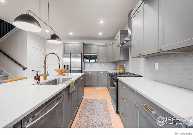 648 Greenspire Dr Unit 6, Windsor, CO 80550 - kitchen with stainless steel appliances, gray cabinets, light wood-type flooring, light countertops, and decorative backsplash