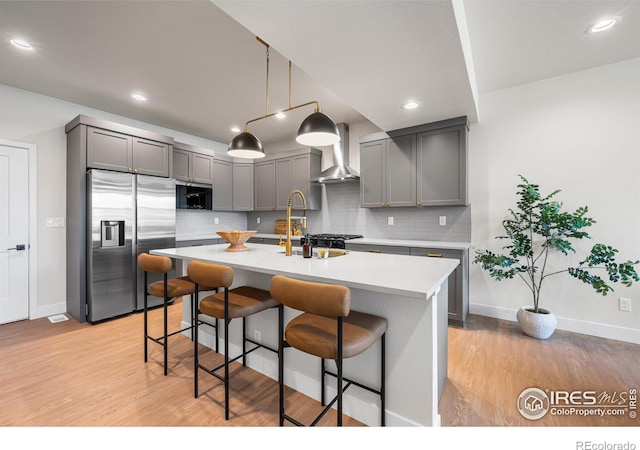 648 Greenspire Dr Unit 6, Windsor, CO 80550 - kitchen featuring appliances with stainless steel finishes, wall chimney exhaust hood, gray cabinets, light countertops, and recessed lighting