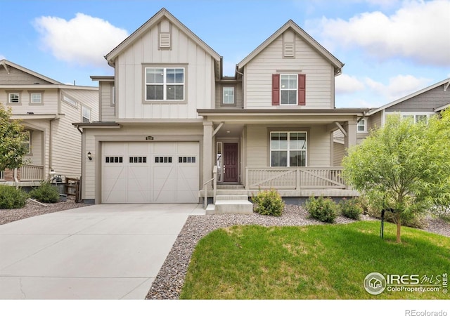 5226 Inland Ave, Firestone, CO 80504 - craftsman-style home with a porch, concrete driveway, a garage, board and batten siding, and a front yard