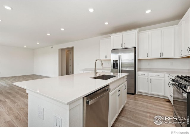 5226 Inland Ave, Firestone, CO 80504 - kitchen featuring stainless steel appliances, recessed lighting, light wood-style floors, and white cabinets