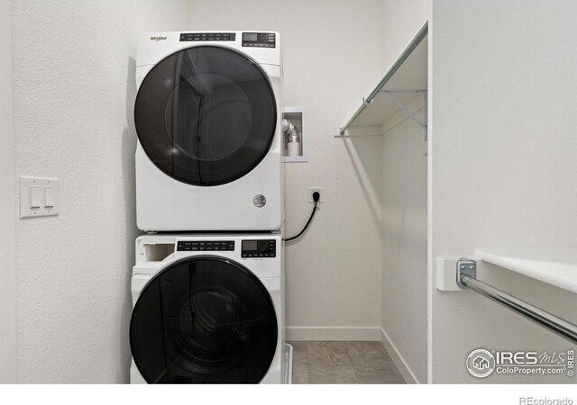 5226 Inland Ave, Firestone, CO 80504 - laundry area featuring stacked washer and clothes dryer and baseboards