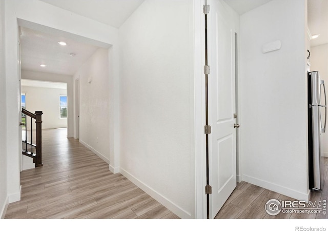 5226 Inland Ave, Firestone, CO 80504 - hallway featuring light wood finished floors, recessed lighting, and stairway