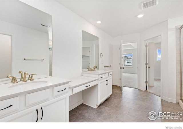 5226 Inland Ave, Firestone, CO 80504 - bathroom with two vanities, a shower stall, recessed lighting, and tile patterned floors