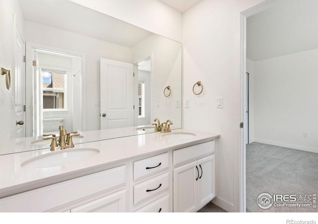 5226 Inland Ave, Firestone, CO 80504 - bathroom featuring double vanity and baseboards