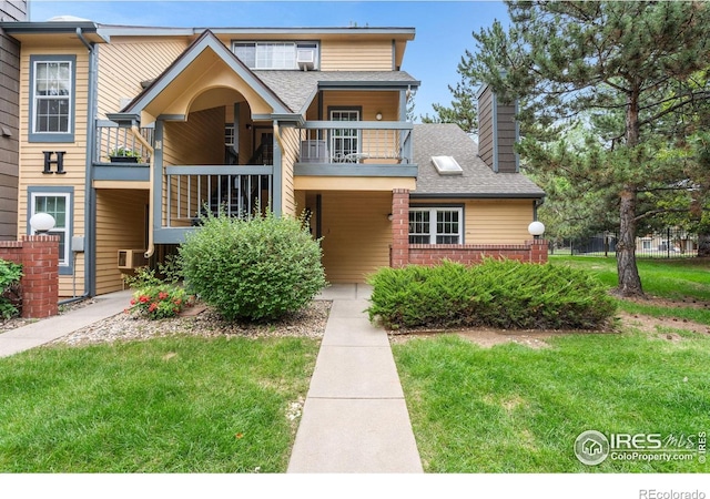 3531 Windmill Dr Unit 3, Fort Collins, CO 80526 - view of front of house featuring a balcony, a chimney, a shingled roof, and a front yard