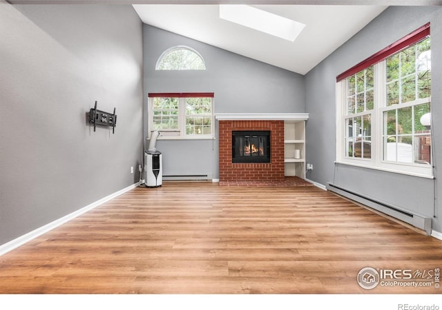 3531 Windmill Dr Unit 3, Fort Collins, CO 80526 - unfurnished living room with a baseboard radiator, a skylight, light wood finished floors, a brick fireplace, and high vaulted ceiling