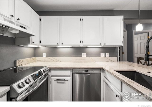 3531 Windmill Dr Unit 3, Fort Collins, CO 80526 - kitchen with stainless steel appliances, under cabinet range hood, white cabinetry, light stone countertops, and pendant lighting