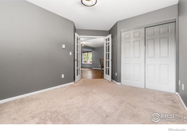 3531 Windmill Dr Unit 3, Fort Collins, CO 80526 - unfurnished bedroom featuring carpet floors, a closet, and french doors