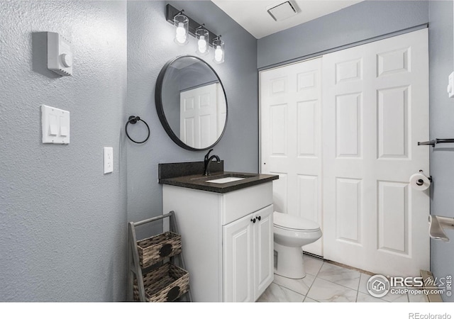 3531 Windmill Dr Unit 3, Fort Collins, CO 80526 - bathroom with vanity, marble look tile flooring, and a textured wall