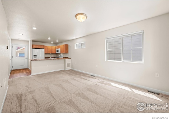67 Quail Rd, Longmont, CO 80501 - unfurnished living room featuring light carpet and recessed lighting