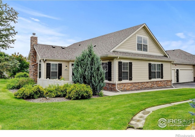 2421 Santa Fe Dr Unit B, Longmont, CO 80504 - view of front of property with roof with shingles, stone siding, a chimney, a front lawn, and a garage