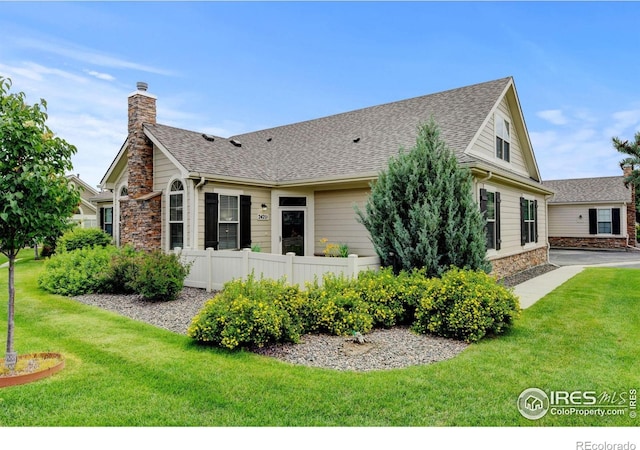 2421 Santa Fe Dr Unit B, Longmont, CO 80504 - rear view of property with roof with shingles, a chimney, and stone siding