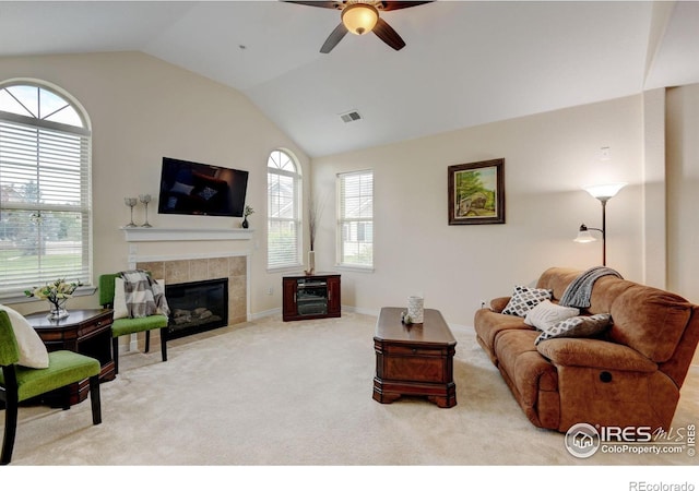 2421 Santa Fe Dr Unit B, Longmont, CO 80504 - carpeted living area featuring a ceiling fan, a tiled fireplace, and vaulted ceiling