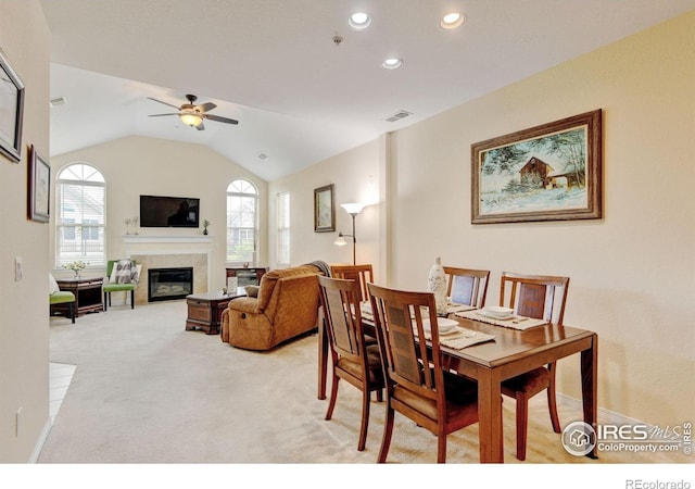 2421 Santa Fe Dr Unit B, Longmont, CO 80504 - dining area with light carpet, ceiling fan, a tiled fireplace, recessed lighting, and vaulted ceiling