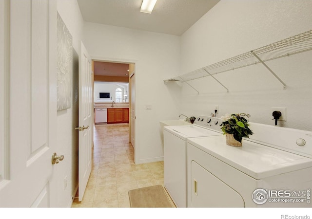 2421 Santa Fe Dr Unit B, Longmont, CO 80504 - washroom featuring washer and clothes dryer and light tile patterned floors