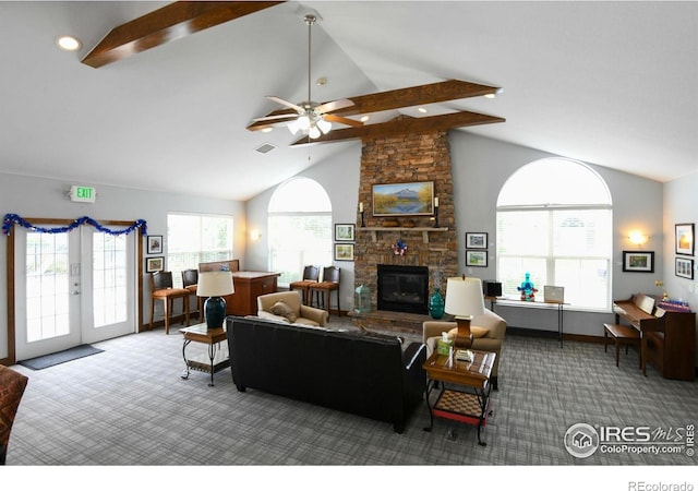 2421 Santa Fe Dr Unit B, Longmont, CO 80504 - carpeted living area with plenty of natural light, a stone fireplace, high vaulted ceiling, ceiling fan, and beam ceiling