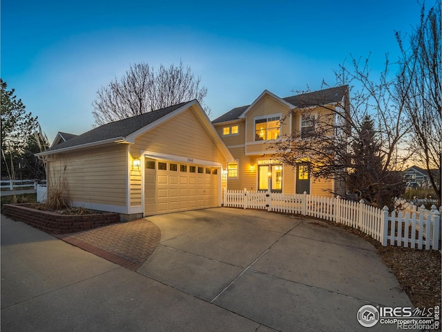 2946 Shoshone Trl, Lafayette, CO 80026 - traditional-style house featuring a fenced front yard, an attached garage, and driveway