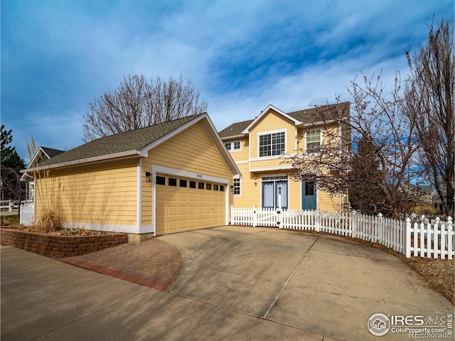 2946 Shoshone Trl, Lafayette, CO 80026 - traditional-style house featuring a fenced front yard and driveway