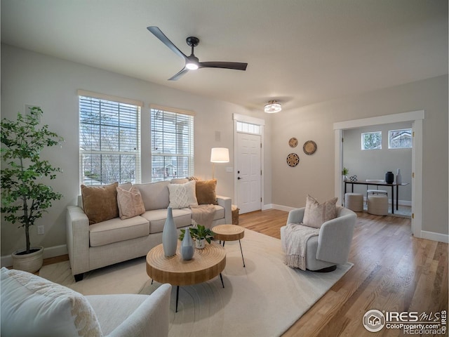 2946 Shoshone Trl, Lafayette, CO 80026 - living area featuring healthy amount of natural light, light wood finished floors, and ceiling fan